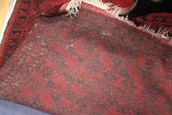 An Afghan red ground rug, 235 x 340cm